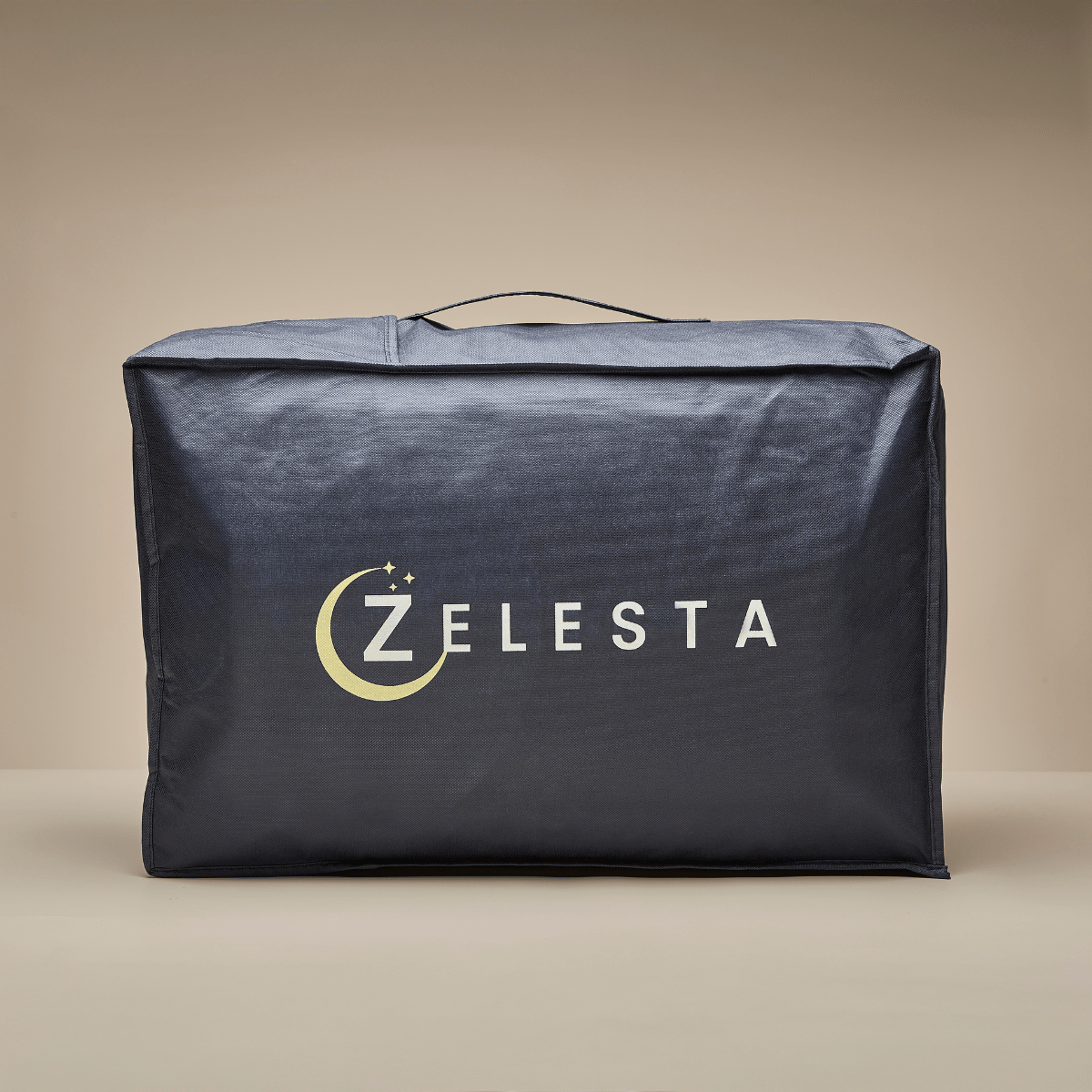 A dark blue rectangular bag with a top handle and “ZELESTA” on the front features a crescent moon and stars by the Z—ideal for storing your Zelesta Teddybed - Panther Anthracite plush duvet.