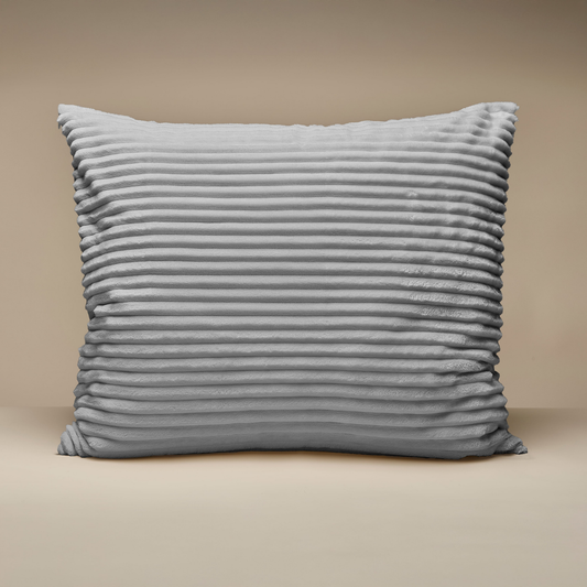 The Zelesta Teddy Groovebed Pillowcase Set of 2 in grey features ribbed pillowcases, adding style and coziness to any bedding arrangement against a beige background.