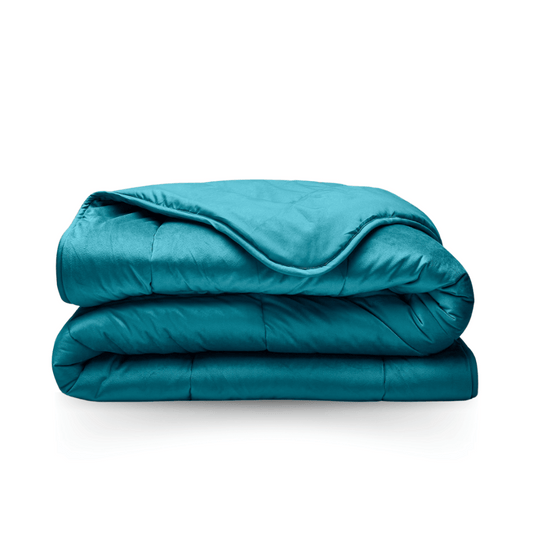 The Zelesta Velvetbed - Petrol weighted blanket, neatly folded in a teal shade, serves as hypoallergenic bedding and is displayed on a white background.