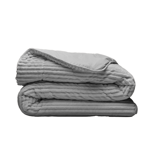 The Zelesta Groovebed - Grey weighted blanket, featuring plush ribbed teddy fabric and a textured surface, is neatly folded and displayed on a plain white background.